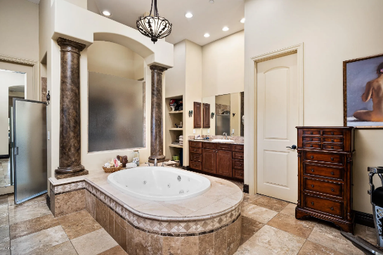A bathroom with a large tub and a sinkAI-generated content may be incorrect.
