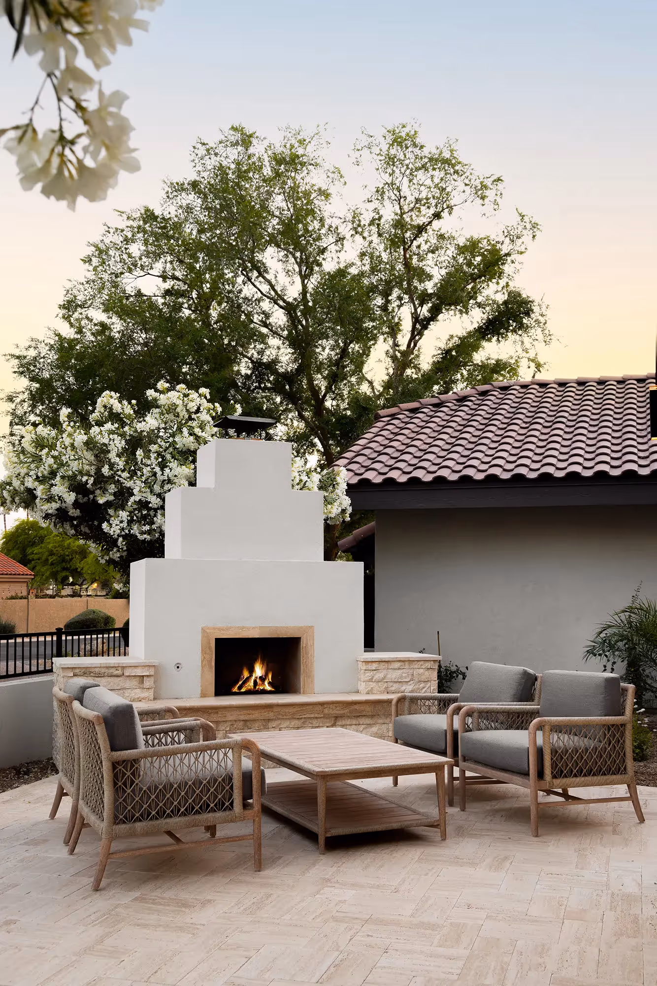 Outdoor fireplace seating area scottsdale wellness home | Sesshu Design Associates